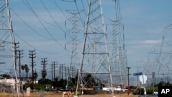 A jogger runs in extreme heat under high tension electrical lines in the North Hollywood section of Los Angeles on Aug. 15, 2020. 