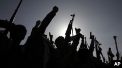 FILE - Houthi supporters raise weapons as they shout slogans during an anti-U.S. and anti-Israel rally in Sanaa, Yemen, on Feb. 14, 2025.