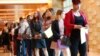 FILE - Job applicants line up at the Seminole Hard Rock Hotel & Casino Hollywood during a job fair in Hollywood, Florida, June 4, 2019. 