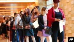 FILE - Job applicants line up at the Seminole Hard Rock Hotel & Casino Hollywood during a job fair in Hollywood, Florida, June 4, 2019. 