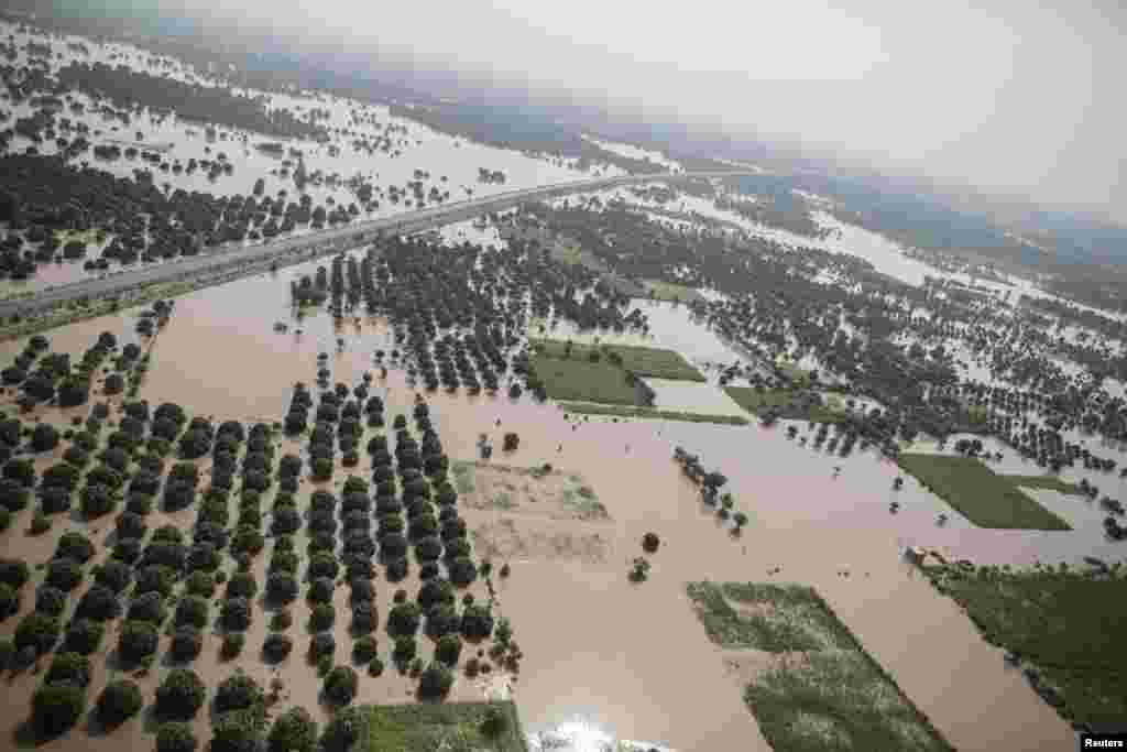 An aerial view taken from a Pakistani air force helicopter shows a flooded area in Multan, Punjab province. The flooding has killed 450 people in India and Pakistan, with the heaviest rainfall in the Kashmir region in 50 years.