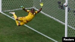 Nigeria's goalkeeper Vincent Enyeama seems to defy gravity in the net for Nigeria at the Brasilia national stadium in Brasilia, June 30, 2014.