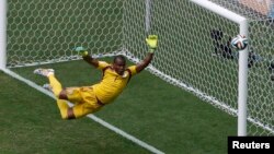 Nigeria's goalkeeper Vincent Enyeama seems to defy gravity in the net for Nigeria at the Brasilia national stadium in Brasilia, June 30, 2014.