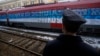 A railroad worker stands by the first train decorated with letters that read "Kosovo is Serbian" written in twenty languages departing from Belgrade to Mitrovica, Kosovo, Jan. 14, 2017.