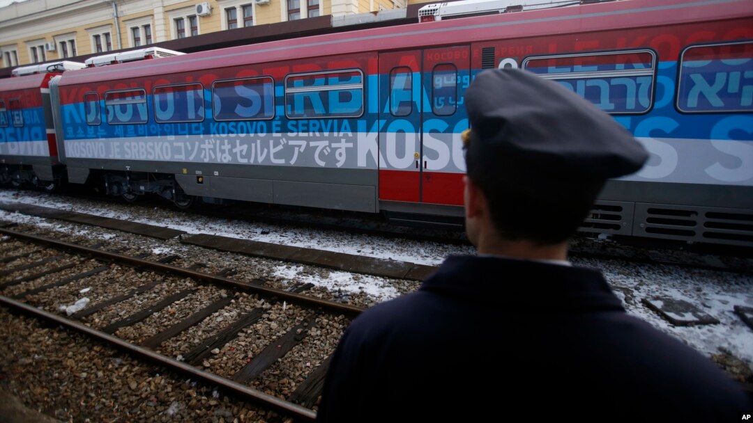 A railroad worker stands by the first train decorated with letters that read "Kosovo is Serbian" written in twenty languages departing from Belgrade to Mitrovica, Kosovo, Jan. 14, 2017.