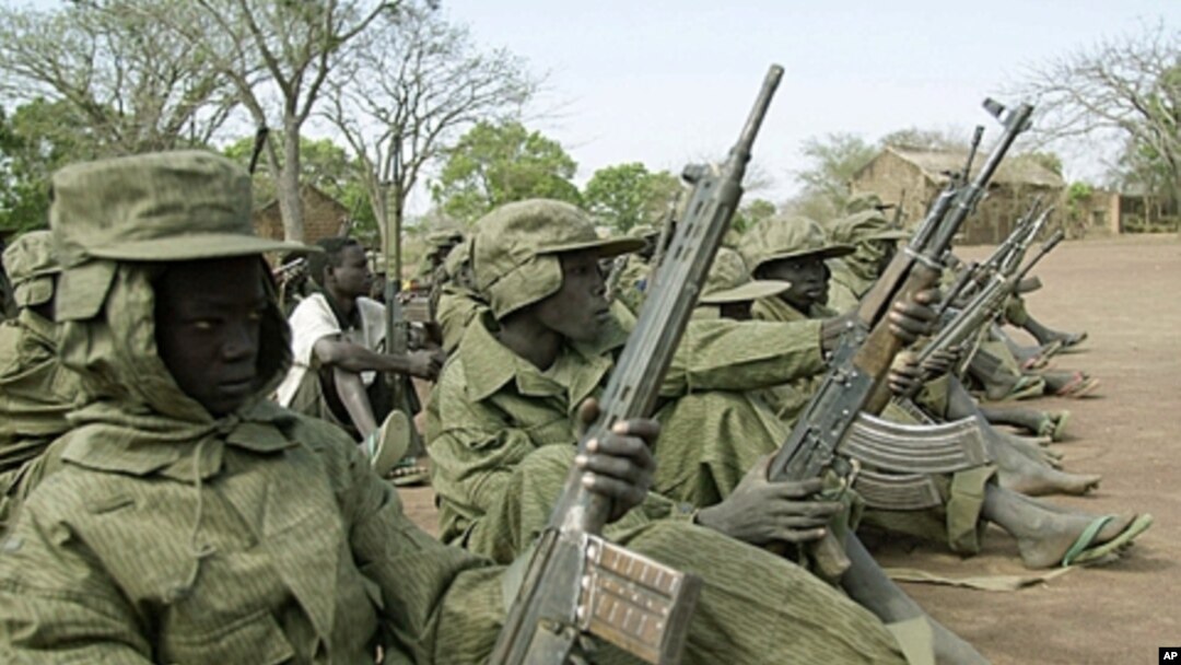 Child soldiers of the rebel Sudan People's Liberation Army (SPLA) wait for their commander at a demobilization ceremony at their barracks in Malou, southern Sudan Sunday, February 25, 2001 (file photo).