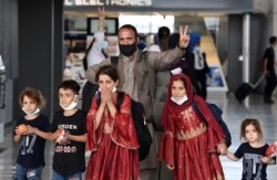 Afghan refugees arrive at Dulles International Airport on Aug. 27, 2021 in Dulles, Virginia, after being evacuated from Kabul following the Taliban takeover of Afghanistan.