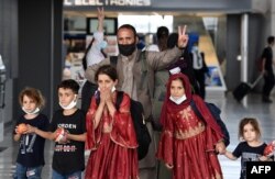 Afghan refugees arrive at Dulles International Airport on Aug. 27, 2021 in Dulles, Virginia, after being evacuated from Kabul following the Taliban takeover of Afghanistan.