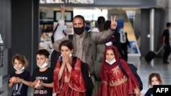 FILE - Afghan refugees arrive at Dulles International Airport on August 27, 2021, in Dulles, Virginia.