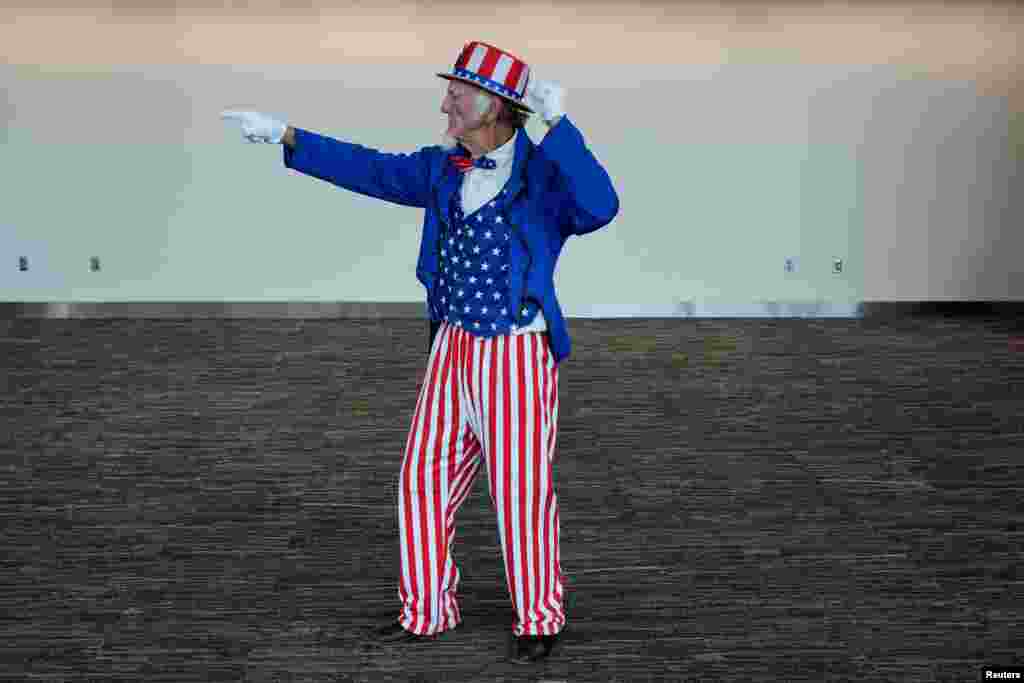 A man dressed as Uncle Sam gestures on the day Republican presidential nominee former U.S. President Donald Trump holds a campaign rally in Erie, Pennsylvania.