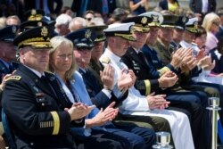 Army Chief of Staff Gen. Mark Milley, left, and others, applaud during a full honors welcoming ceremony for Secretary of Defense Mark Esper at the Pentagon, July 25, 2019.