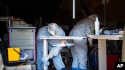 Medical staff cleans a tent where Covid-19 patients are being treated at the Tshwane District Hospital in Pretoria, South Africa, July 10, 2020.