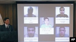 Nuevo Leon State Governor Rodrigo Medina (L) speaks next to photographs of five men believed to be members of the Zetas drug cartel who were arrested in connection with an arson attack at a casino last week that killed 52 people, in Monterrey, Mexico, Aug
