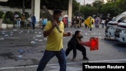 Royalists clash with pro-democracy protesters during an anti-government protest in Bangkok, Nov. 17, 2020.