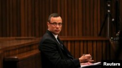 Olympic and Paralympic track star Oscar Pistorius sits in the dock during his trial for the murder of his girlfriend Reeva Steenkamp, at the North Gauteng High Court in Pretoria, March 25, 2014. 