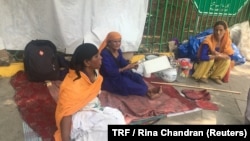 Homeless women sit amidst their belongings on a pavement in New Delhi, which has among the most homeless people in India, July 4, 2018. 