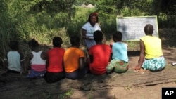 FILE - Photo taken in the Gorongosa National Park, Mozambique, shows Mozambican girls participating in a program that aims to help them stay in school longer and avoid child marriage, a longstanding problem in the southern African country, April 20, 2018. 