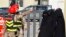 Family members (R) of radical Muslim cleric Abu Qatada walk past security personnel as they arrive to attend his trial at the State Security Court in Amman, Jordan, Dec. 10, 2013. 