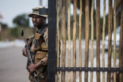 A South African Defense Force soldier stands at the entrance of The Protea Hotel Ranch Resort in Polokwane on March 13, 2020, where the 122 South African citizens evacuated from the coronavirus epicenter of Wuhan in China are to be quarantined.