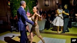 President Barack Obama and first lady Michelle Obama do the tango with dancers during the State Dinner at the Centro Cultural Kirchner, March 23, 2016, in Buenos Aires, Argentina. 