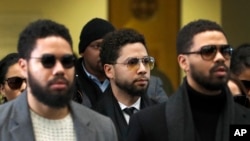 Actor Jussie Smollett, center, departs after an initial court appearance at the Leighton Criminal Courthouse, Feb. 24, 2020, in Chicago. 