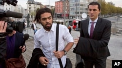 Co-defendant and key witness Jejoen Bontinck, left, arrives at the main courthouse in Antwerp, Belgium on Sept. 29. He is charged with being a member of Sharia4Belgium, which allegedly recruited fighters to go to Syria. 