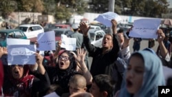 FILE - Afghan women chant during a protest in Kabul, Afghanistan, Oct. 21, 2021
