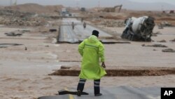 An Omani civil defense staff member visits a road cut by flood water after Cyclone Merkunu hit Salalah, Oman, May 26, 2018.