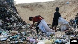 Children sift through waste at a landfill in Khan Yunis in the southern Gaza Strip on Oct. 15, 2024, amid the ongoing war between Israel and the Palestinian militant group Hamas in the besieged Palestinian territory. 