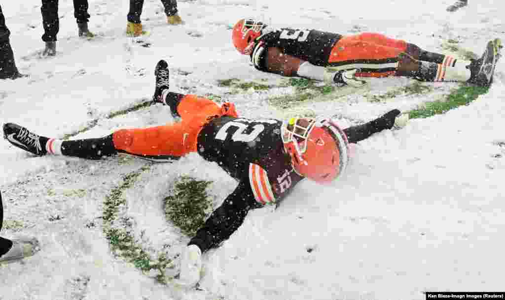 Cleveland Browns safety Rodney McLeod Jr. (12) and defensive end Ogbo Okoronkwo (54) celebrate in the snow after the Browns beat the Pittsburgh Steelers at Huntington Bank Field in Cleveland, Ohio, Nov. 21, 2024.&nbsp;Mandatory Credit: Ken Blaze-Imagn Images