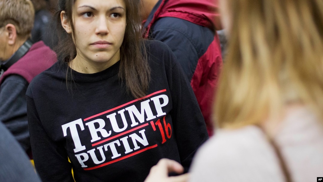 FILE - A woman wears a shirt reading "Trump Putin '16" while waiting for Republican presidential candidate Donald Trump to speak at a campaign event at Plymouth State University in Plymouth, N.H., Feb. 7, 2016. ﻿In a recent outreach to Putin, Trump not on
