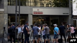 Journalists gather outside the private health center where the first Argentine infected with the coronavirus, COVID-19, is located, in Buenos Aires, March 3, 2020. 
