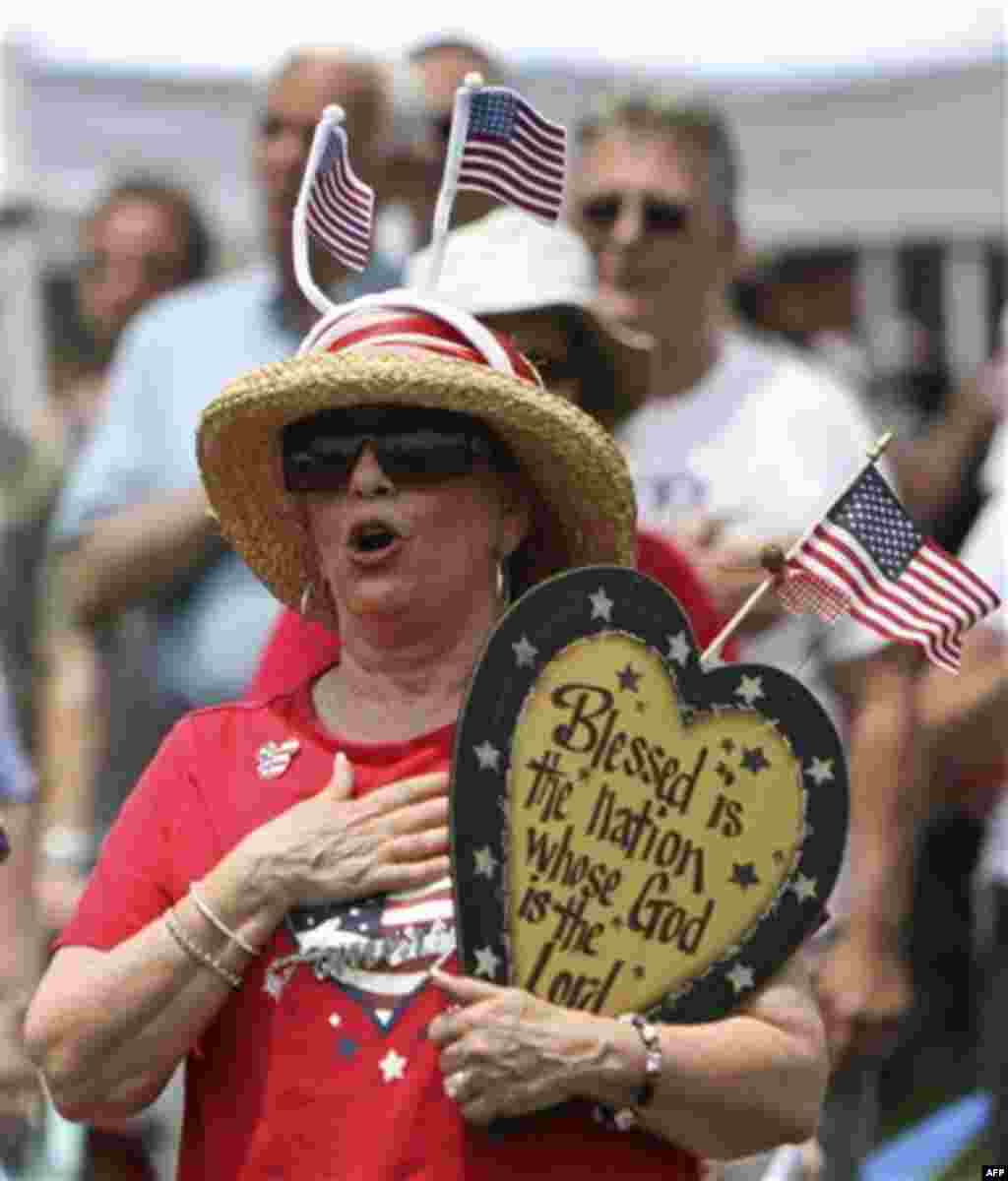 Harriet Ricchini, along with other audience members, sings the National Anthem during the 'Energy Independence Day Tea Party' rally on Independence Mall in Philadelphia, on Monday July 4, 2011. (AP Photo/ Joseph Kaczmarek)