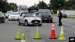 Cars are turned away from the entrance of Arlington National Cemetery, in Arlington, Va., Aug. 22, 2018.