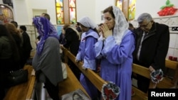 Iraqi Christians pray during a mass on Christmas at St George Chaldean Catholic Church in Baghdad, Iraq, Dec. 25, 2018. 