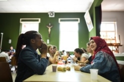 FILE - Young people attend a meeting between asylum-seekers and French children in Ferrette, France, April 24, 2019. This tiny town near the Swiss border in eastern France has opened its doors to asylum-seekers who now are 10% of the population.