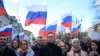 Russian opposition leader Alexei Navalny, his wife, Yulia, opposition politician Lyubov Sobol and other demonstrators march in memory of slain Kremlin critic Boris Nemtsov in Moscow, Feb. 29, 2020. 