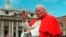 FILE - In this file photo taken on April 23 1997, Pope John Paul II waves to faithful as he crosses St. Peter's square at the Vatican.