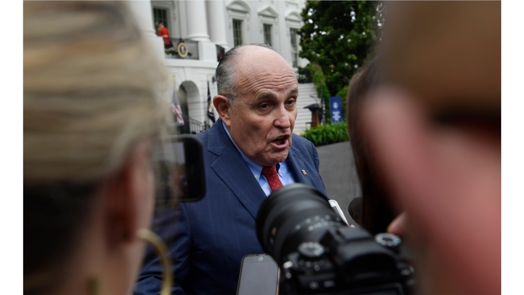 FILE - President Donald Trump's lawyer Rudy Giuliani speaks to reporter's on the South Lawn of the White House in Washington, May 30, 2018.