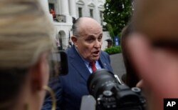 FILE - President Donald Trump's lawyer Rudy Giuliani speaks to reporter's on the South Lawn of the White House in Washington, May 30, 2018.