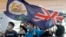 A protester waves a Hong Kong colonial flag in a shopping mall during a protest in Hong Kong, June 12, 2020. 