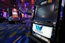 Video gaming machines are widely spaced at WaterView Casino in Vicksburg, Miss., May 20, 2020. Employees were cleaning and sanitizing before opening the casino doors Thursday, following a two-month shutdown because of the coronavirus.