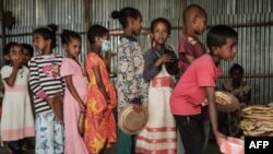 FILE - Children wait in line for food in Mekele, the capital of Ethiopia's conflict-ridden Tigray region, June 23, 2021.