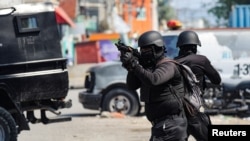 FILE—Police officers take part in an operation on the surroundings of the National Penitentiary following a fire, in Port-au-Prince, Haiti, March 14, 2024.