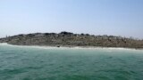 People walk on an island that reportedly emerged off the Gwadar coastline in the Arabian Sea.&nbsp;A deadly magnitude 7.7 earthquake struck in the remote district of Awaran in Pakistan&#39;s Baluchistan province with enough force to create a small island visible off the southern coast, Pakistani officials said.