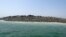 People walk on an island that reportedly emerged off the Gwadar coastline in the Arabian Sea.&nbsp;A deadly magnitude 7.7 earthquake struck in the remote district of Awaran in Pakistan's Baluchistan province with enough force to create a small island visible off the southern coast, Pakistani officials said.