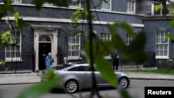 FILE - Britain's Prime Minister Theresa May leaves 10 Downing Street, as she faces a vote on alternative Brexit options, in London, March 27, 2019. 