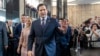 Secretary of State Marco Rubio greets people as he arrives to speak to State Department staff followed by his family, at the State Department, Jan. 21, 2025, in Washington. 