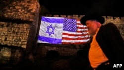 A picture taken on Dec. 6, 2017, shows a giant U.S. flag screened alongside Israel's national flag by the Jerusalem municipality on the walls of the old city.