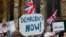 FILE - Pro-Brexit demonstrators wave flags and banners outside Parliament in London.